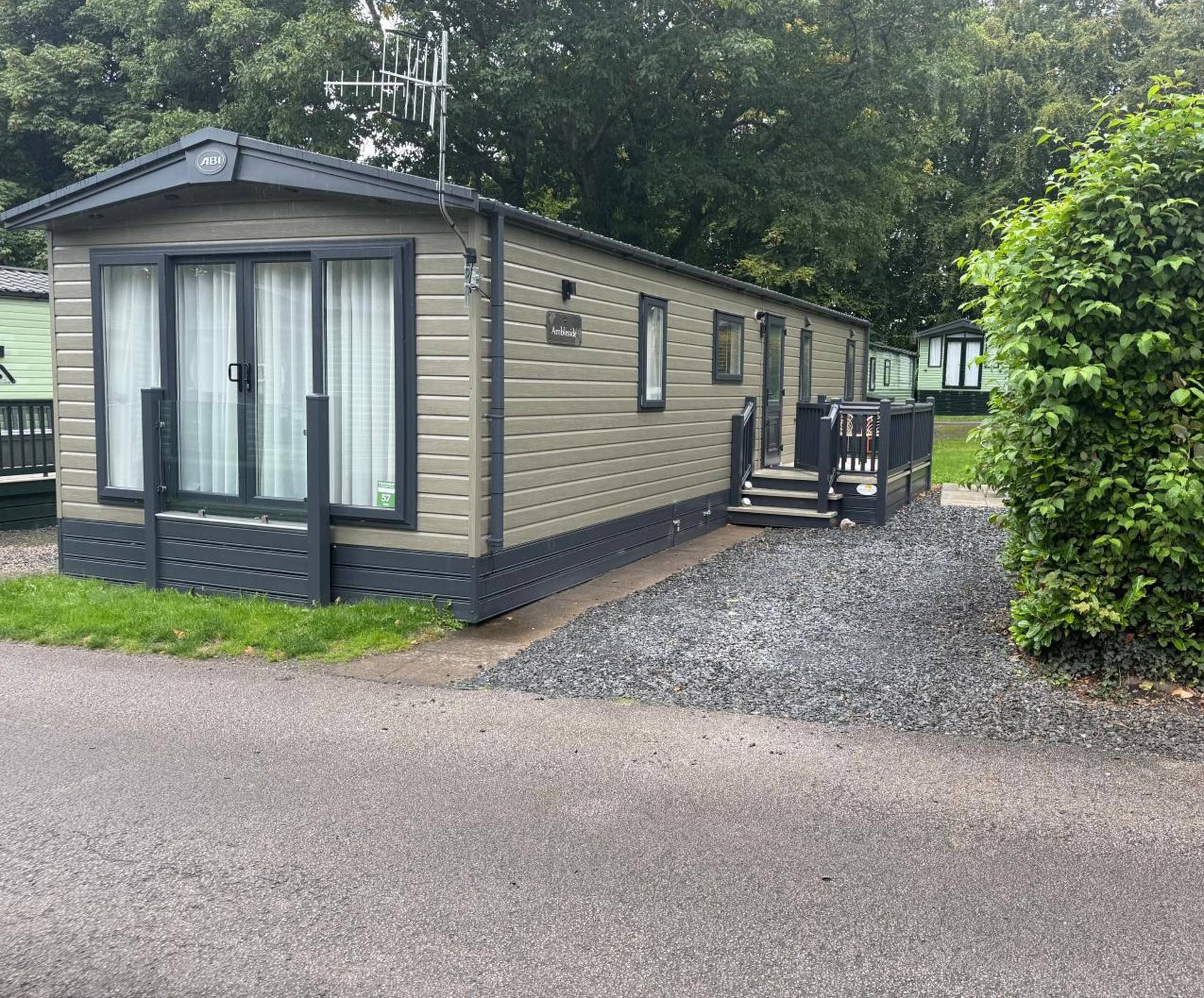 The new holiday caravan: olive cladding, French doors and steps up to the deck